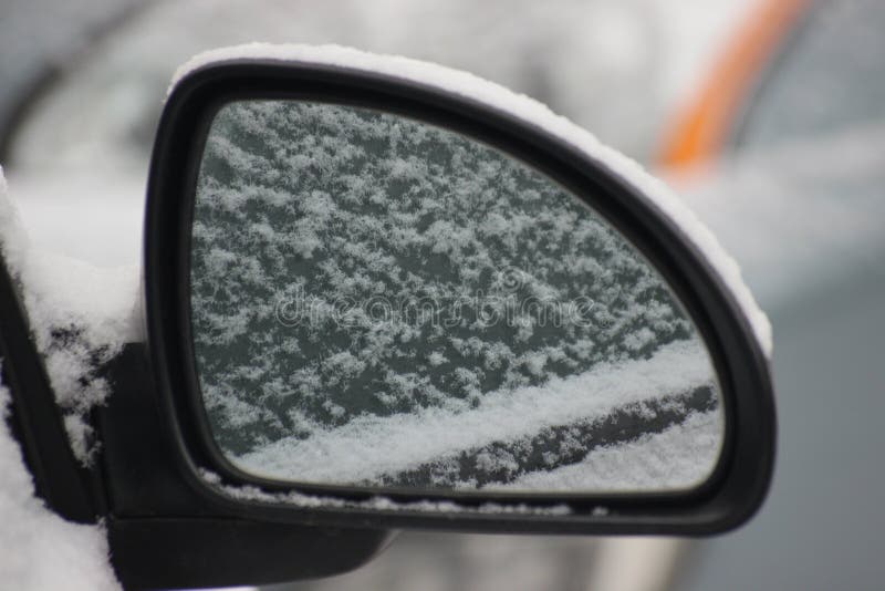 Light Snow on the Mirror of a Silver Car, Reflected in the Mirror. the