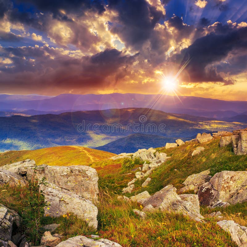 Light on stone mountain slope with forest at sunset