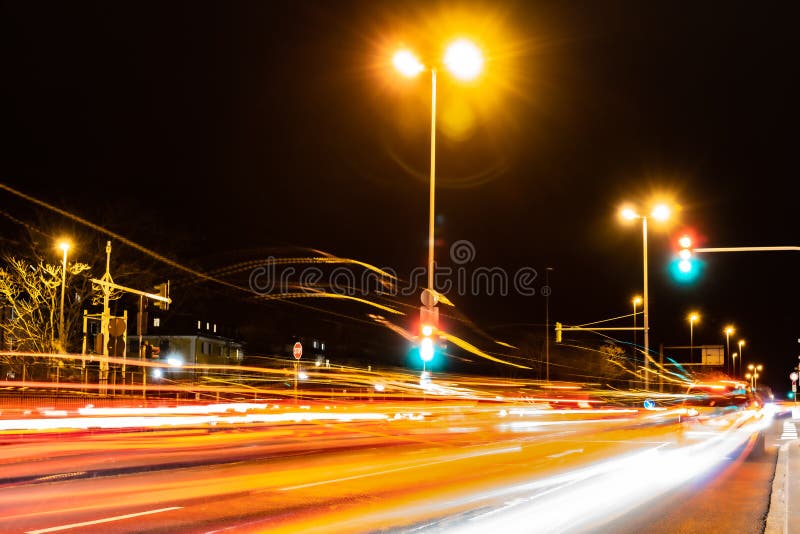 Light Stripes of Cars Driving Over an Intersection at Night Stock Photo