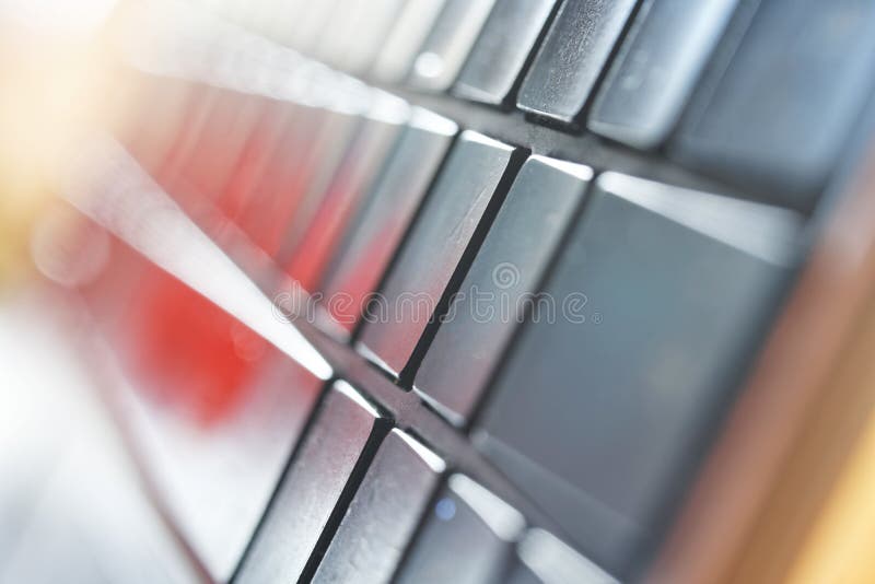 The light, thin keyboard of a modern silver laptop, photographed from an unusual angle. Technogenic abstraction. Macro. Bokeh. Selective focusing. Close-up