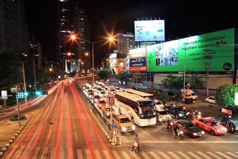 BANGKOK-AUG 10: Light trails on Ratchadaphisek street at Asoke intersection on August 10,2012 in Bangkok,Thailand. Ratchadaphisek steet is established on 1971 to celebrate 25th reign of King Bhumibol.