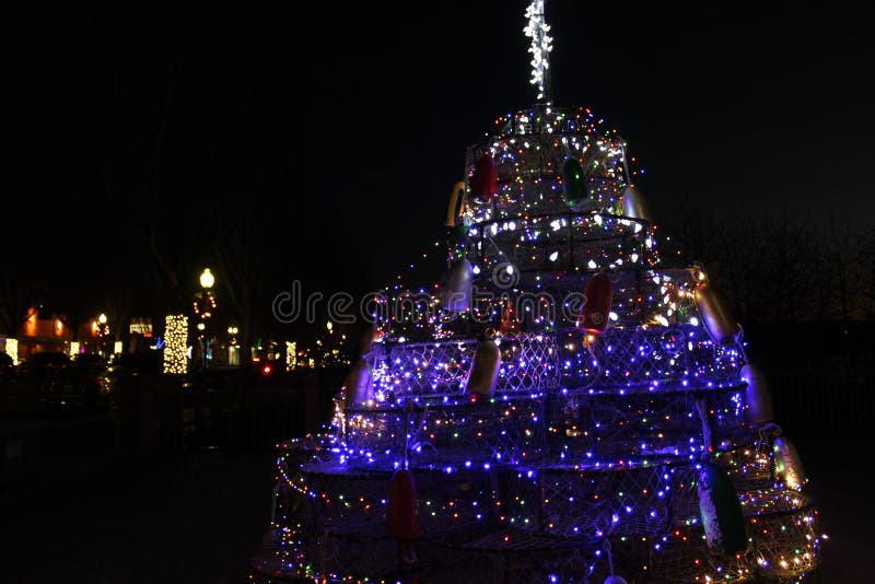 A Christmas Tree Made Fish Nets with Lights and a Star Stock Photo