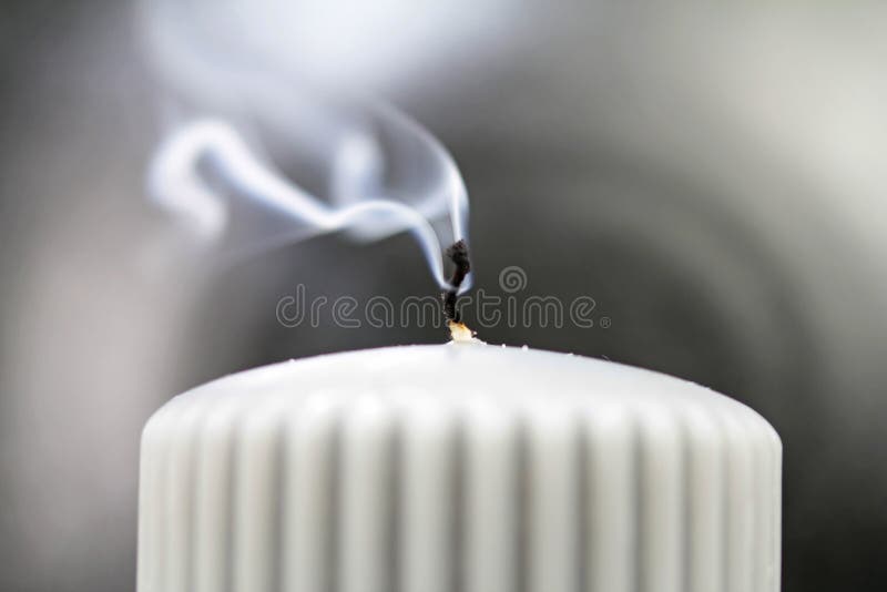 Light the wick of a candle with a match stock photo