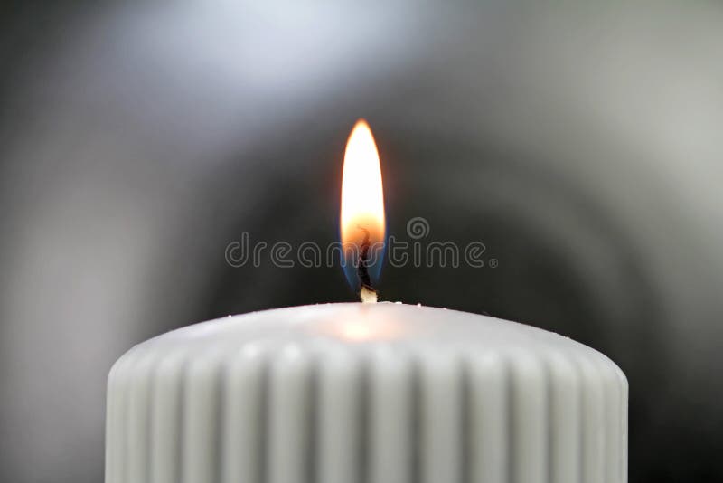 Light the wick of a candle with a match royalty free stock photos