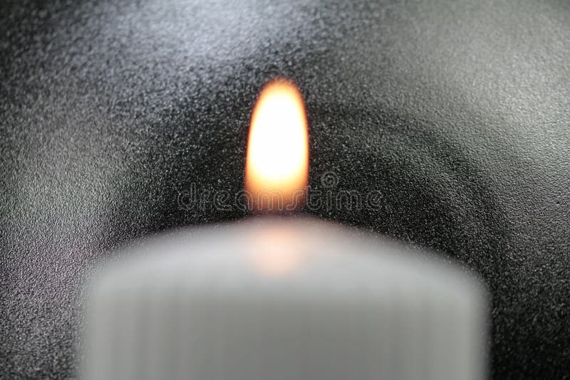 Light the wick of a candle with a match royalty free stock photo
