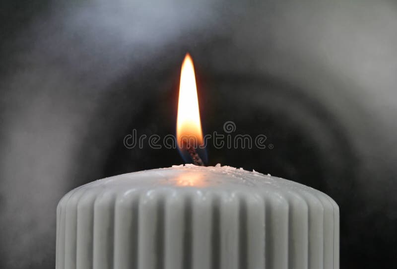 Light the wick of a candle with a match stock photos