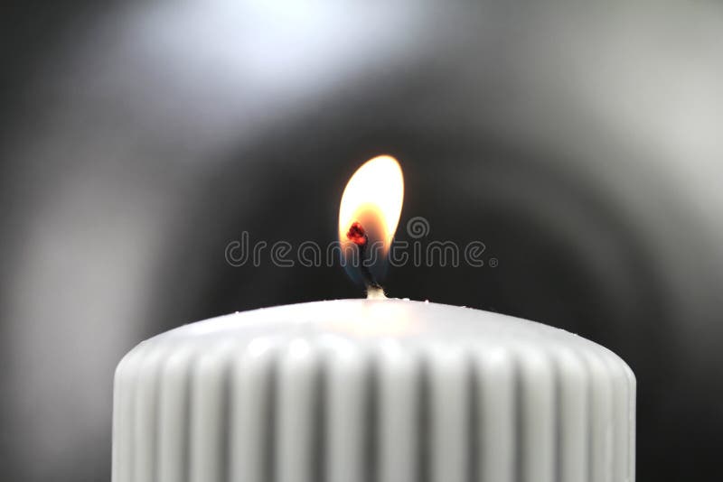 Light the wick of a candle with a match royalty free stock photography