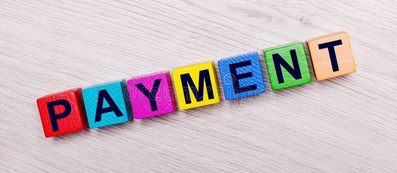 On a light wooden background on multi-colored bright wooden cubes the word PAYMENT stock photography