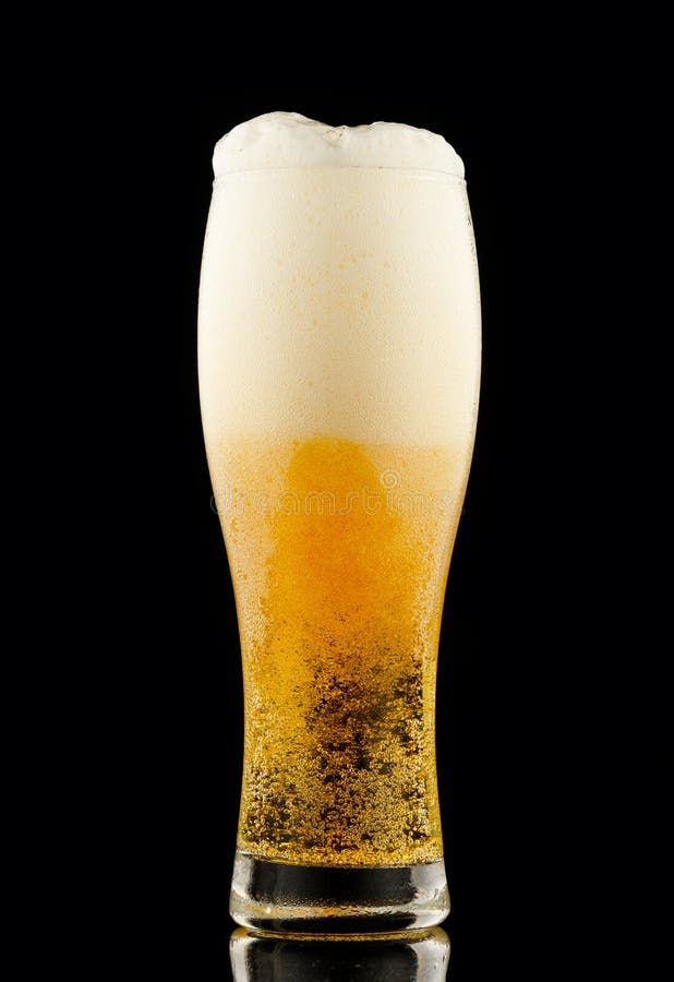 Light Yellow Beer with Foam in a Glass Black Background Stock Image