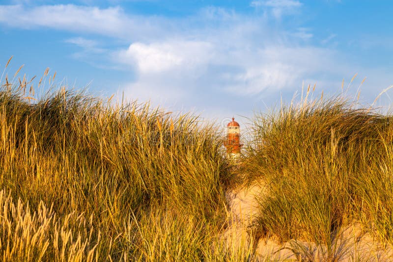 Lighthouse behind sand hill