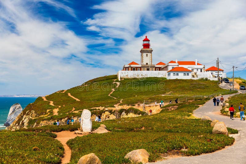 The lighthouse in Cabo da Roca. Cliffs and rocks on the Atlantic ocean coast in Sintra in a beautiful summer day, Portugal. Cabo da Roca, Portugal. Lighthouse and cliffs over Atlantic Ocean. The lighthouse in Cabo da Roca. Cliffs and rocks on the Atlantic ocean coast in Sintra in a beautiful summer day, Portugal. Cabo da Roca, Portugal. Lighthouse and cliffs over Atlantic Ocean