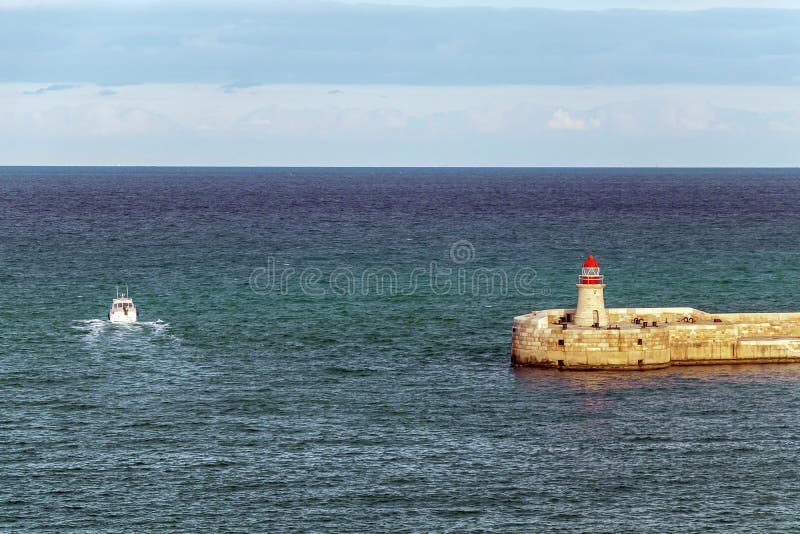 Lighthouse in the Mediterranean Sea Waters in Sunny Day with Blue Sky