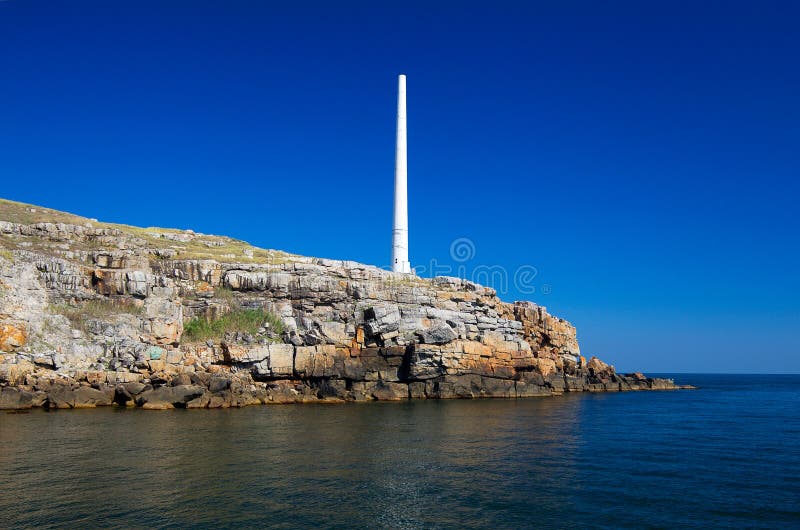 The Lighthouse on the Rocky Shore of Snake Island Stock Photo Image