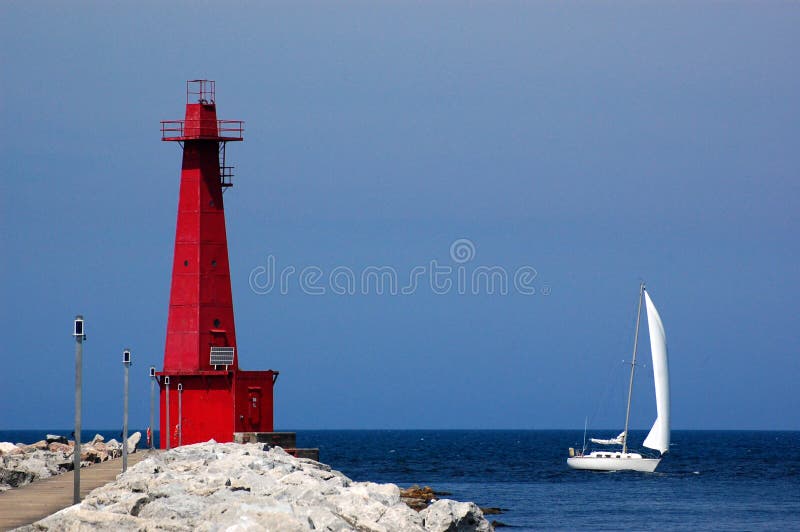 Lighthouse and sailboat, Muskegon, MI stock photography Lighthouse and sailboat, Muskegon, MI stock photography
