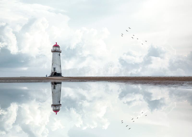 Lighthouse standing pool of water stunning dramatic storm clouds reflection reflected water sea steps up to building Wales sea