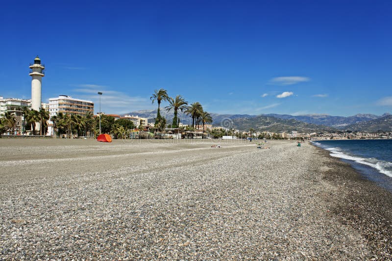 Lighthouse and stoney beach at Torre del Mar