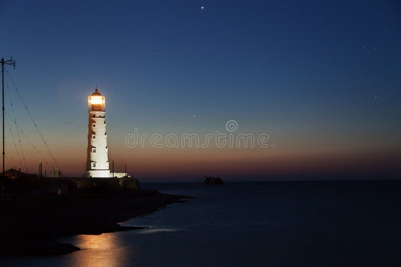 Lighthouse on the water edge near sea