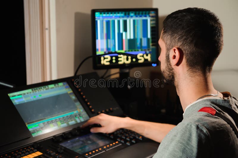 A Lighting Engineer Works with Lights Technicians Control Stock Image