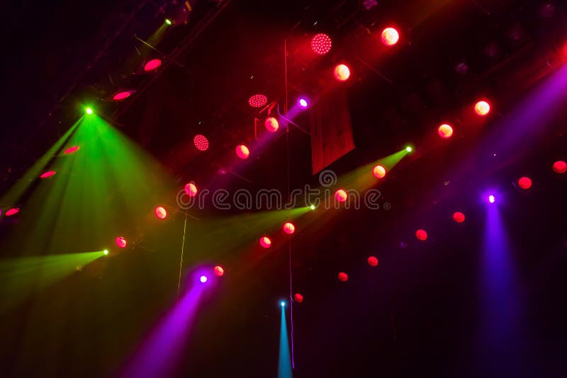 Lighting equipment on the stage of a theatre or concert hall. The rays of light from spotlights. Halogen and led light bulbs