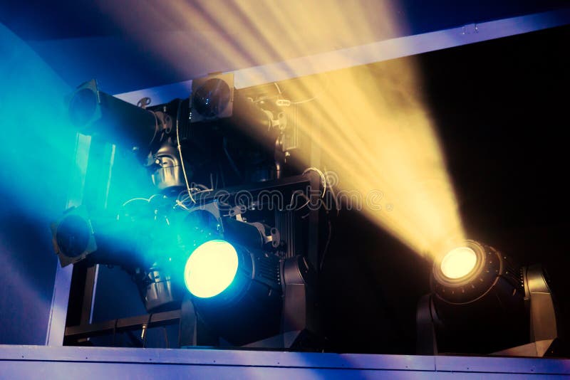 Lighting equipment on the stage of the theatre during the performance. The light rays from the spotlight through the smoke