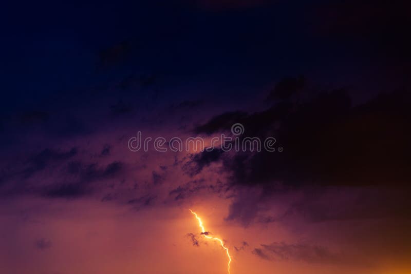 Lightning Bolts Against the Backdrop of a Thundercloud. Stock Photo
