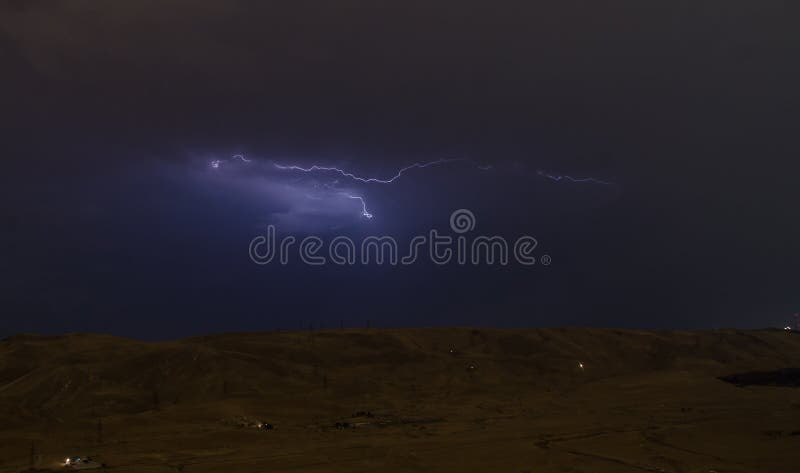 Lightning with dramatic clouds. Night thunder-storm over the mountain and the lake in Baku, Azerbaijan stock photo Lightning with dramatic clouds. Night thunder-storm over the mountain and the lake in Baku, Azerbaijan stock photo