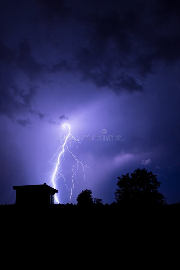 Lightning Flashes Over the Night Sky during Thunderstorm Stock Photo