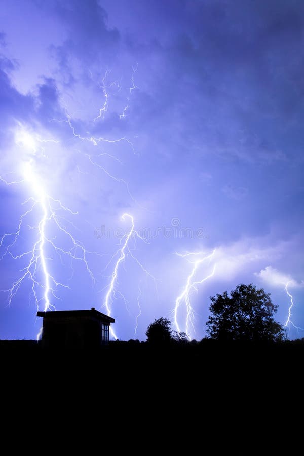 Lightning Flashes Over the Night Sky during Thunderstorm Stock Photo