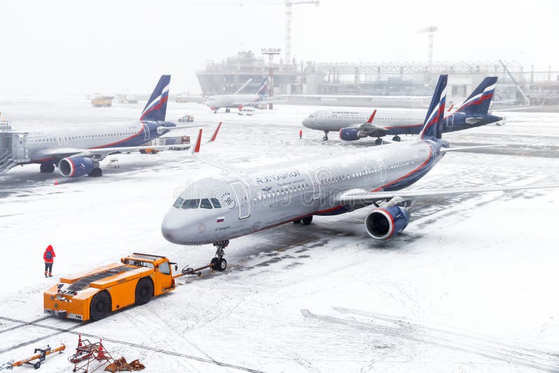Moscow, Russia - December 2, 2018: Aeroflot Russian Airlines Airbus A321 taxiing in the Sheremetyevo International Airport during a heavy snowfall. Moscow, Russia - December 2, 2018: Aeroflot Russian Airlines Airbus A321 taxiing in the Sheremetyevo International Airport during a heavy snowfall