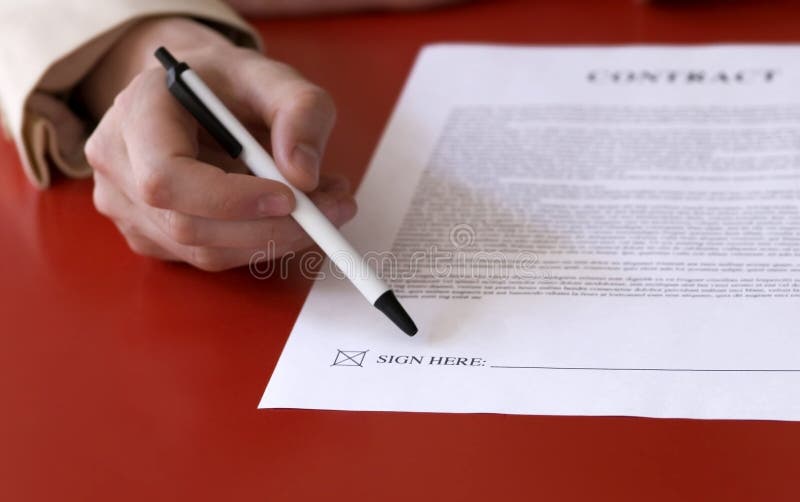 Businesswoman pointing to signature line with ballpoint pen - sign here. Businesswoman pointing to signature line with ballpoint pen - sign here