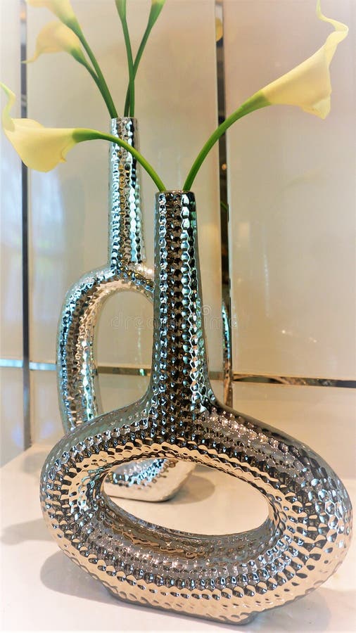 Lilies are Placed in Tall and Curved Vases. Stock Photo Image of