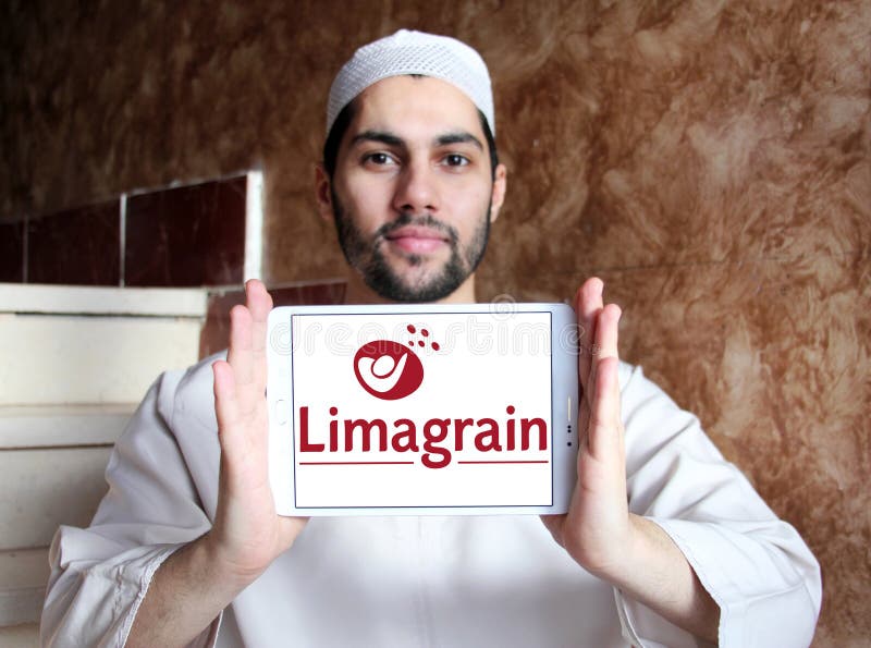 Logo of Limagrain company on samsung tablet holded by arab muslim man. Limagrain is an international agricultural co-operative group, specialized in field seeds, vegetable seeds and cereal products. Logo of Limagrain company on samsung tablet holded by arab muslim man. Limagrain is an international agricultural co-operative group, specialized in field seeds, vegetable seeds and cereal products