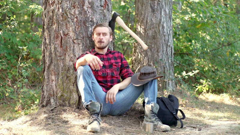 Limberjack pracujący w lesie Przystojny człowiek z siekierą Silny lomberjack z siekierą w koszulce Lumberjack