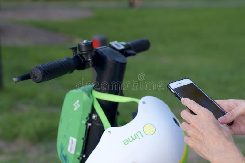 Lime e-scooter handlebar and mobile phone ready for scan