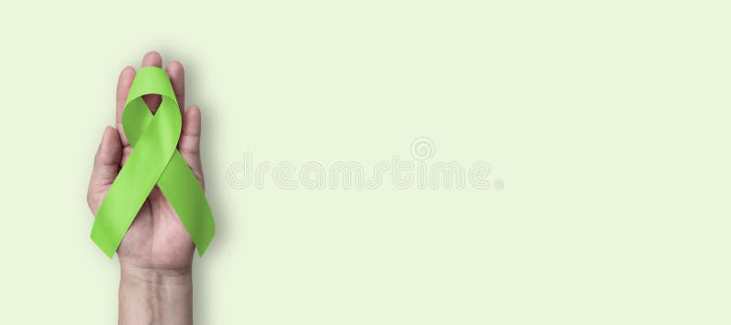 light green ribbon on a white background solidarity with people suffering  from celiac disease Stock Photo by alfotomp