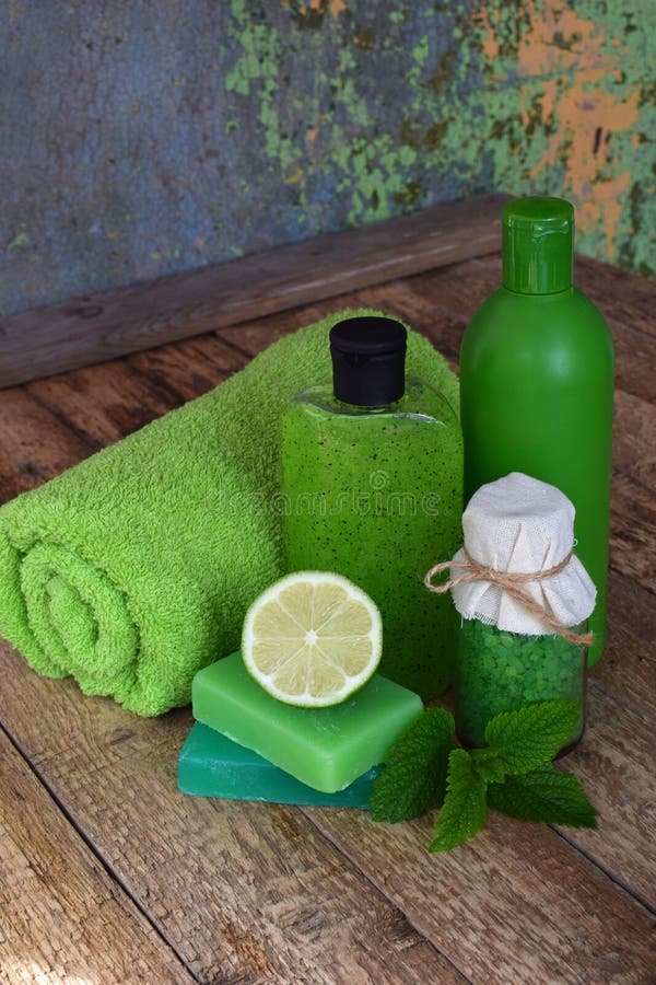 Lime mint composition beauty treatment products in green colors: shampoo, soap, bath salt, towel, oil. Various bath accessories. I