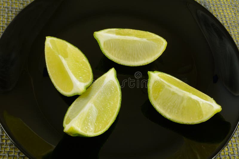 Lime wedges on plate stock photo. Image of wedges, freshness 156219268