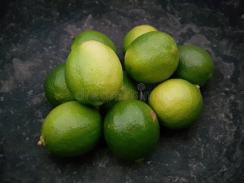 Limes laying in stone bowl for cocktail stock photos Limes laying in stone bowl for cocktail stock photos
