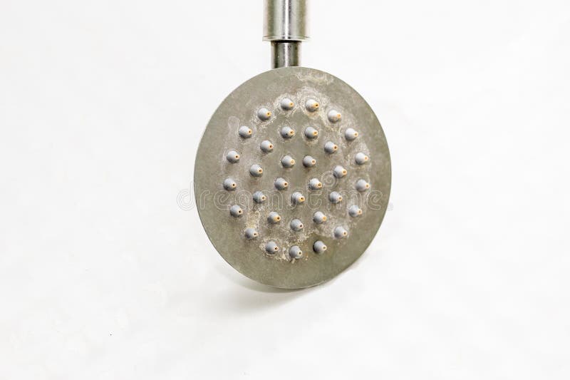Limescale on the shower head and shower cabin. How to remove limescale in the bathroom. Dirty shower head. royalty free stock photography