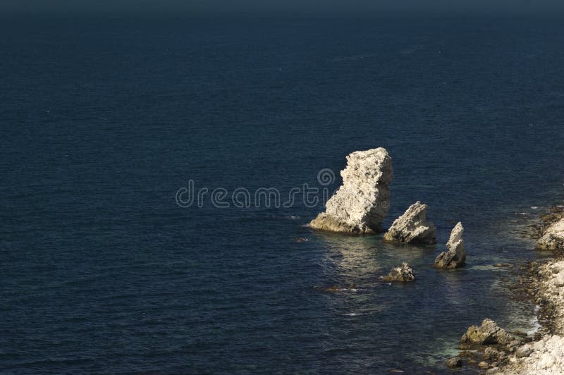 Limestone rock in dark sea water