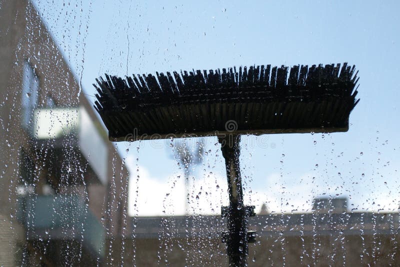 Window glass cleaning with pure water and extension pole. Washing and rinse using a reach and wash system. Window glass cleaning with pure water and extension pole. Washing and rinse using a reach and wash system