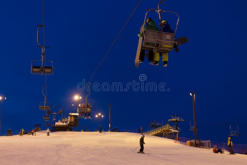 Cableway above snowy slope at ski resort in evening time. Cableway above snowy slope at ski resort in evening time