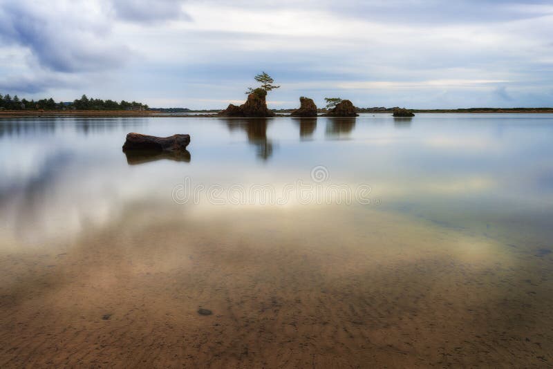 A receding storm leaves behind calm waters and deserted beach in the early evening hours at Siletz Bay in Lincoln City Oregon. A receding storm leaves behind calm waters and deserted beach in the early evening hours at Siletz Bay in Lincoln City Oregon