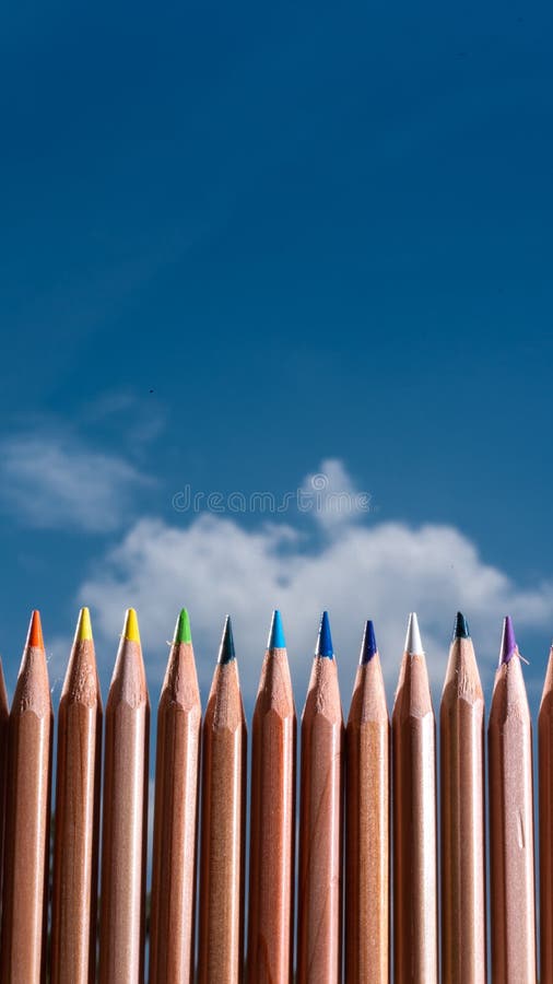 Line of Colored Crayons on a Blue Sky with Clouds Stock Photo Image of pencil, blue 208258098