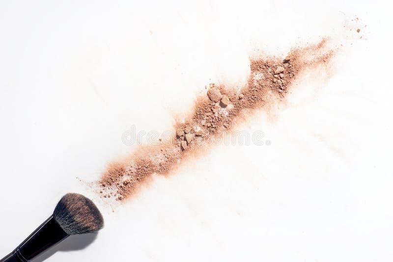 Line of scattered face powder and brush stock image Line of scattered face powder and brush stock image