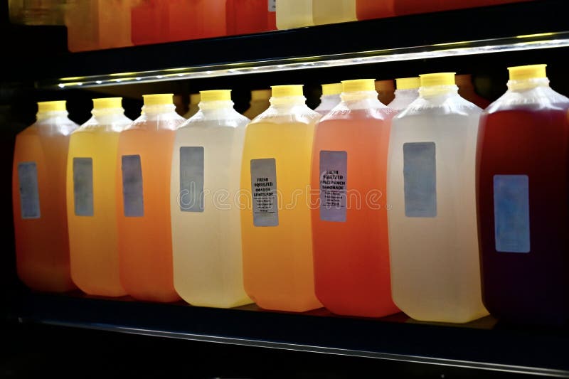 https://thumbs.dreamstime.com/b/line-top-lit-fruit-juice-jugs-sale-colors-orange-lemon-berry-plastic-juice-jugs-233959623.jpg