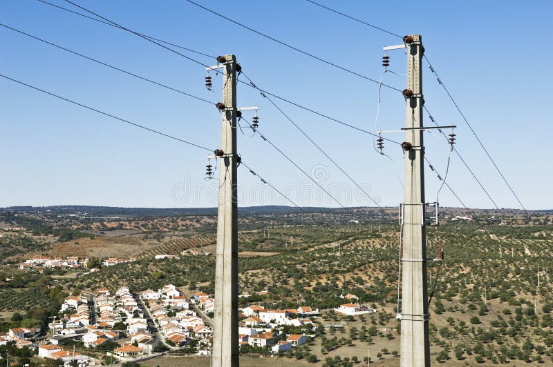 Two concrete electric poles near a small village. Two concrete electric poles near a small village