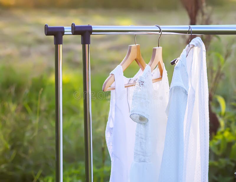 Linen dresses hanging on a hanger outdoors