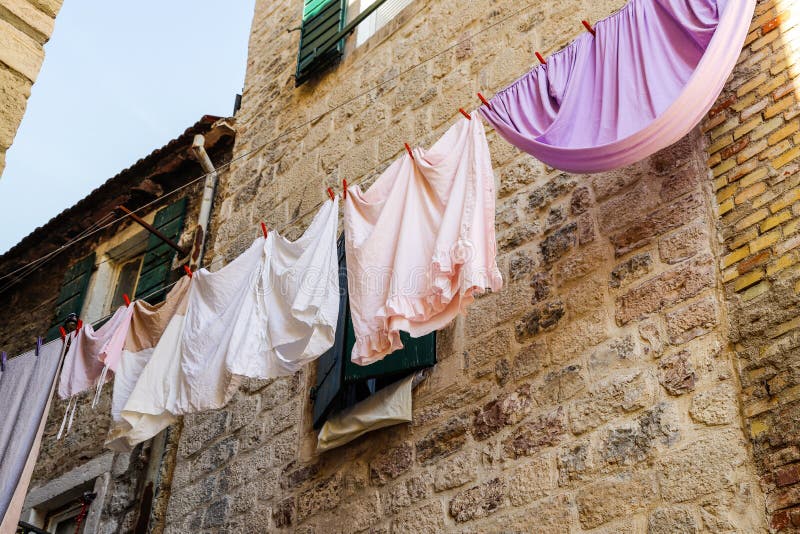 Linen is drying on clothing line in narrow street old town of Kotor, Montenegro. September, 2019 stock photography Linen is drying on clothing line in narrow street old town of Kotor, Montenegro. September, 2019 stock photography