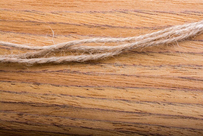 Linen thread strings placed on wooden texture stock image Linen thread strings placed on wooden texture stock image